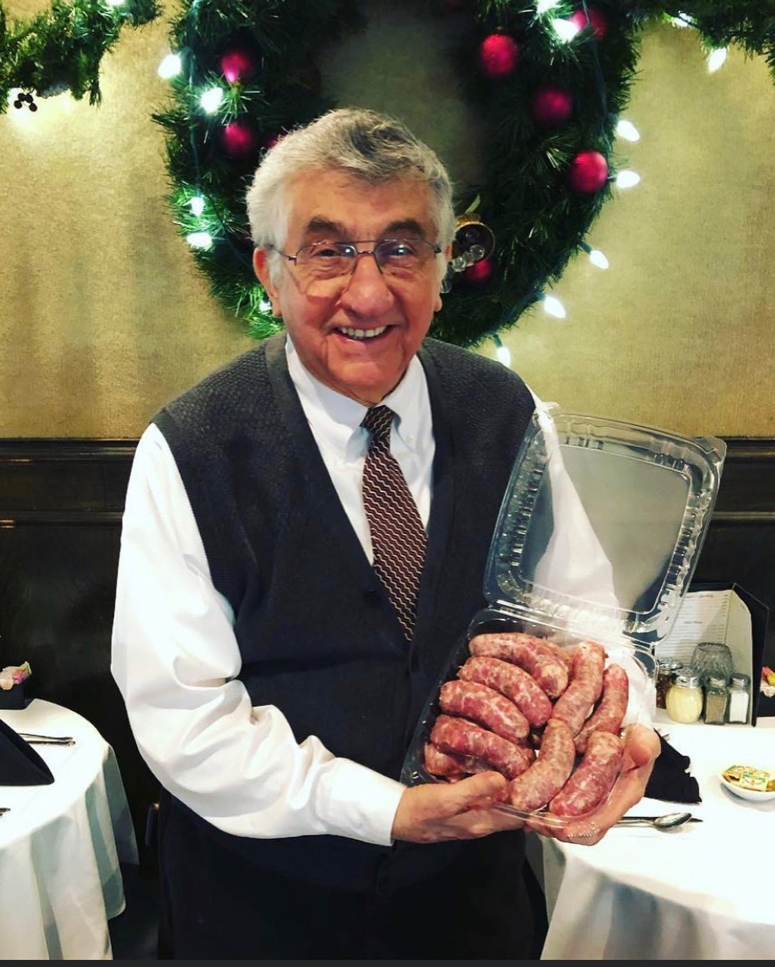 Joe Barraco holding a tray of homemade sausage
